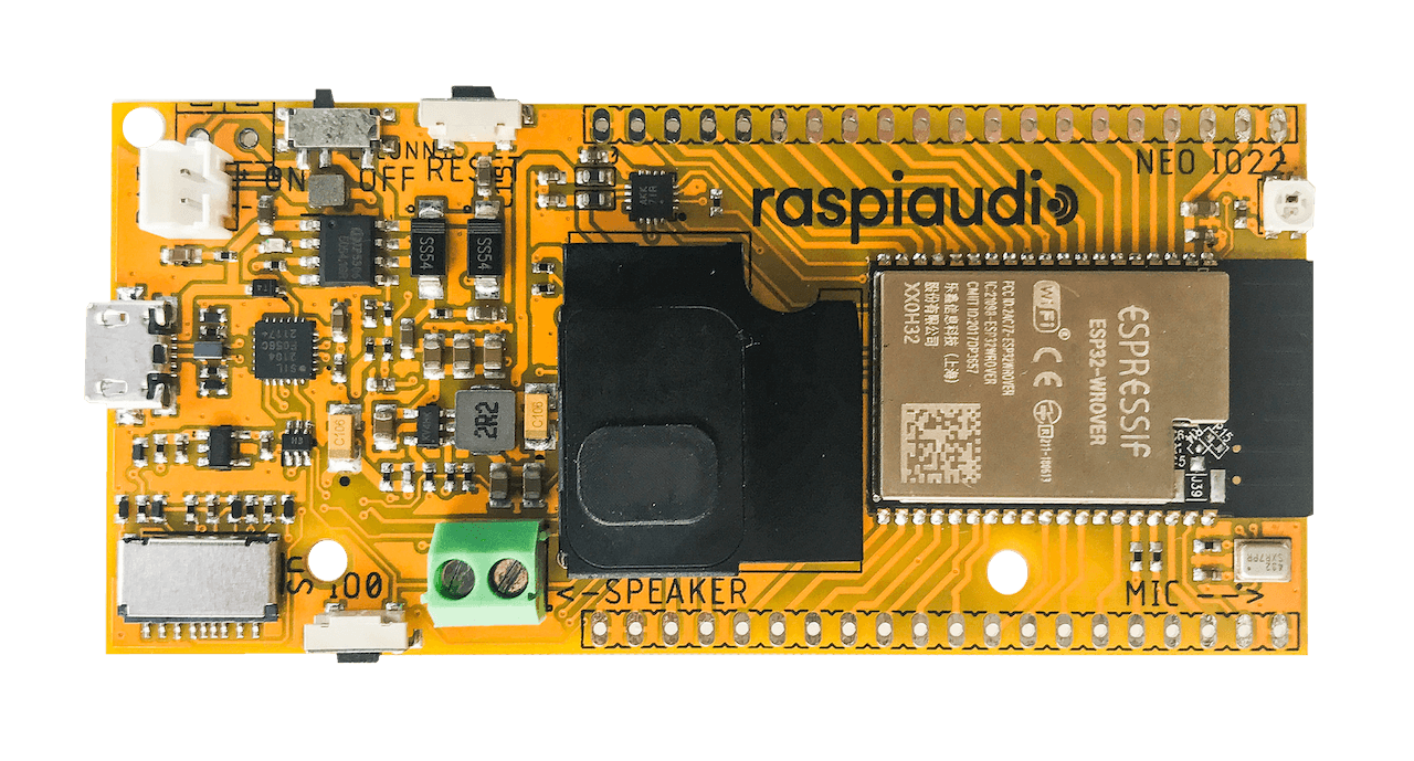 Photo of a yellow PCB with an ESP32 and audio components.