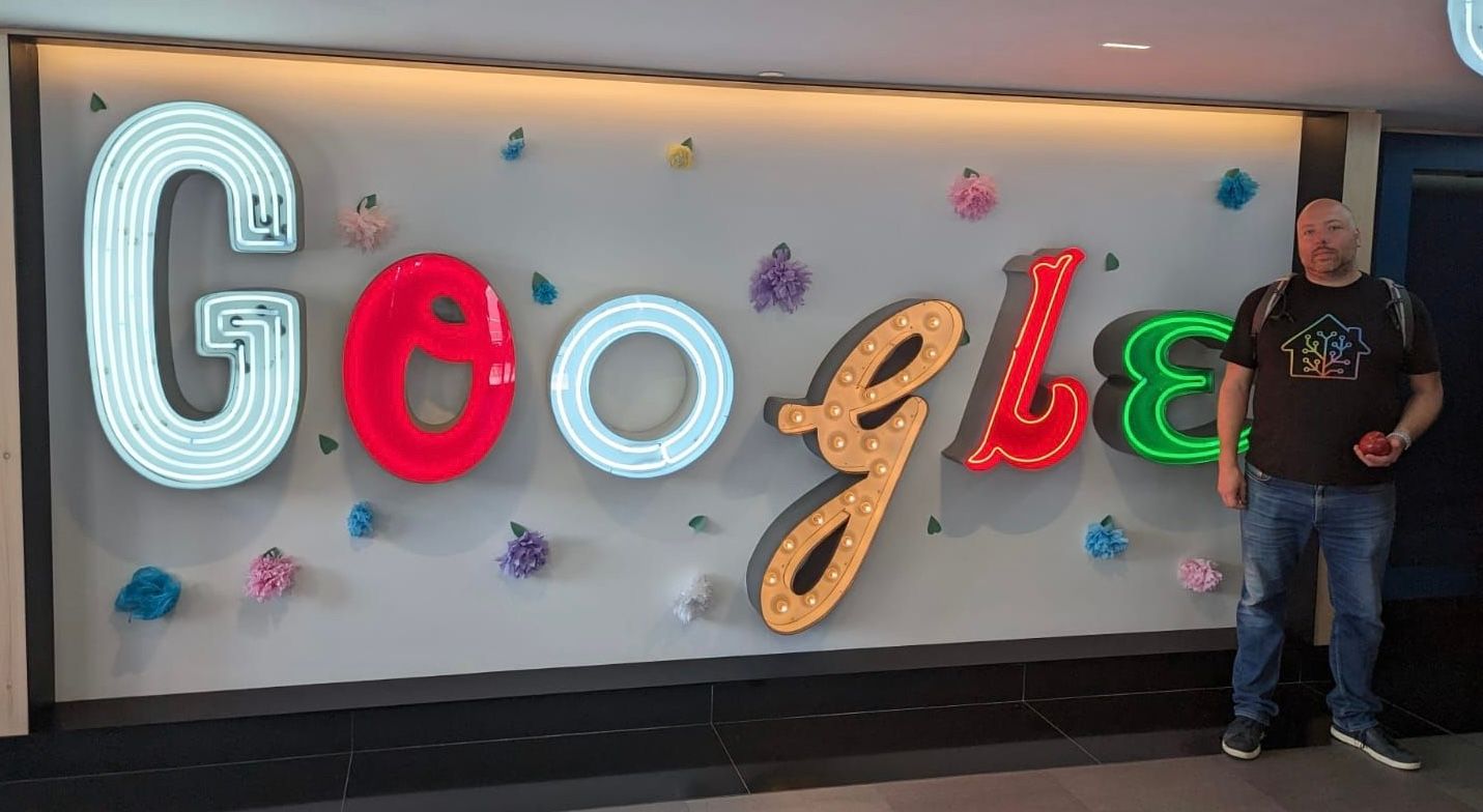 Photo of Paulus Schoutsen in front of a Google logo made out of neon letters.