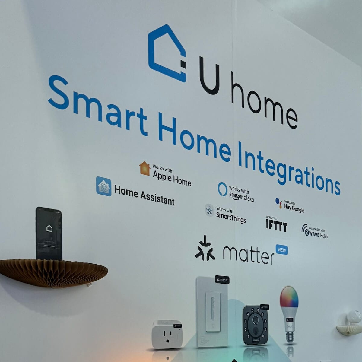 Banner at a booth showing that the U-home products are compatible with Apple, Amazon, Google, Home Assistant and SmartThings.